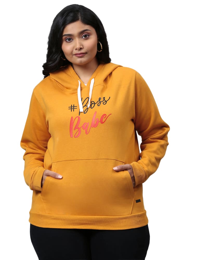 Front of a model wearing a size 4XL Mustard "Boss Babe" Hooded Sweatshirt in Mustard by Instafab Plus. | dia_product_style_image_id:298302